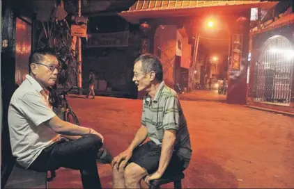  ??  ?? ■ Seniors chat outside their restaurant­s in Tangra. This is where IndianChin­ese food was invented, influenced by the demands of the local population. Bengalis who visited the Chinese joints wanted Chinese food, but on their own terms  saucy and spicy.