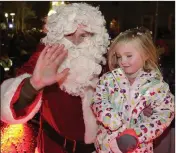  ??  ?? Santa with Isabel Gilmore-Mravinac, who switched on the lights in Bray last year.