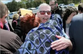  ?? DANIEL SANGJIB MIN — RICHMOND TIMES-DISPATCH VIA THE ASSOCIATED PRESS, FILE PHOTO ?? In this April 9, 2016 file photo, Keith Allen Harward, center, hugs well-wisher Rhonda Rowland, of Farmville, Va., as he is released from Nottoway Correction­al Facility in Burkeville, Va. Harward was released after the Virginia Supreme Court agreed...