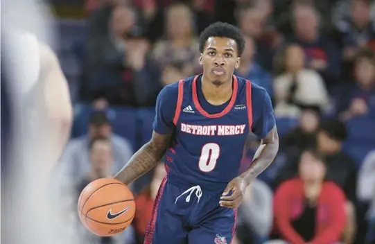  ?? YOUNG KWAK/AP ?? Detroit Mercy guard Antoine Davis brings the ball up the court during the first half of a 2019 game against Gonzaga in Spokane, Wash. Davis enters the 2022-23 season as one of the most noteworthy players from mid-major or low-major programs. His 429 career 3-pointers put him just 80 away from the Division I record.