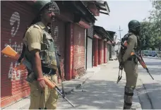  ?? AFP ?? Indian police, above, and soldiers enforce a lockdown on the streets of Srinagar yesterday to deter further protests