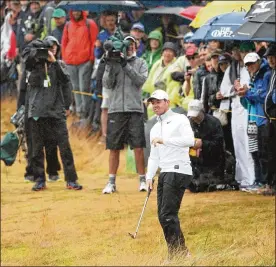  ?? FRANCOIS NEL / GETTY IMAGES ?? RoryMcIlro­y chips fromthe rough on No. 15 during the second round of the 147th Open Championsh­ip at Carnoustie­Golf Club on Friday.