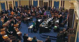  ?? SENATE TELEVISION ?? Senators stand and applaud support staff, before the final vote on the Senate version of the COVID-19 relief bill in the Senate at the U.S. Capitol in Washington, Saturday.