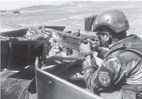  ?? THE ASSOCIATED PRESS ?? An Afghan commando mans a machine gun at the Pandola village near the site of the U.S. forces’ Thursday bombing in Achin district of Jalalabad.