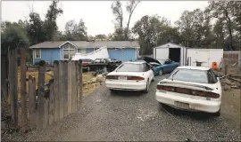  ?? RICH PEDRONCELL­I — ASSOCIATED PRESS ?? Cars are parked in front of the home of Kevin Janson Neal on Wednesday in Rancho Tehama Reserve. The body of Neal’s wife was found at the home, riddled with bullets.