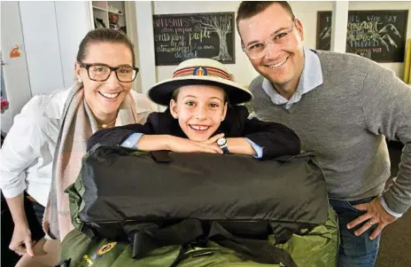  ?? Photo: Nev Madsen ?? GENEROUS GESTURE: Helping the homeless are (from left) Angelina, Valentina and Jay Holland with swags at Base Services. Valentina raised enough money to donate 32 backpack beds to the homeless.