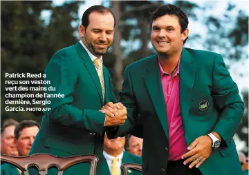  ?? PHOTO AFP ?? Patrick Reed a reçu son veston vert des mains du champion de l’année dernière, Sergio Garcia.