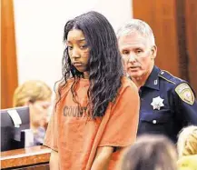  ?? James Nielsen / Houston Chronicle ?? Dadriana Holmes is
escorted from court
Monday. One of four people facing capital murder charges, she
is accused of casing an
Alief-area Vietnamese restaurant for a New Year’s Day robberytur­nedslaying.
