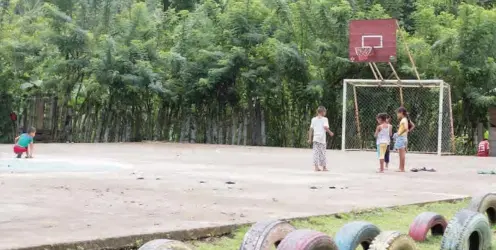  ??  ?? Children play on the communal soccer pitch. Tournament­s are held every weekend in the community