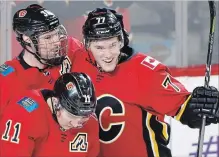  ?? LARRY MACDOUGAL THE CANADIAN PRESS ?? Mark Jankowski, right, with Troy Brouwer, left, and Mikael Backlund, has had plenty to smile about this past season with the Calgary Flames.