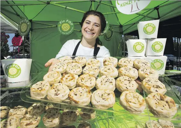  ?? DAVID BLOOM ?? Sama Saidi, who immigrated with her family from Iraq to Edmonton a year ago, sells her savoury Pie Pops at the St. Albert Farmers Market. After growing up in war-torn Iraq, the 36-year-old mother of two is grateful to be living in Canada where “there...