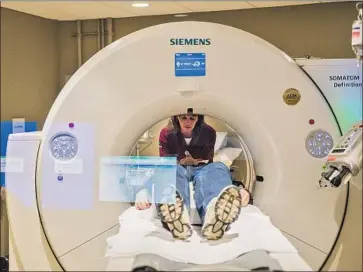  ?? Michael Henninger Washington Post ?? THE UNITED STATES ranks first in the number of CT scans and second in the number of MRIs compared with other wealthy nations. A CT scan costs $896 in the U.S. It costs $500 in Australia and $97 in Canada.