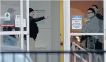  ??  ?? DOMESTIC DISPUTE: Law enforcemen­t officers including Chicago SWAT work an entrance at Mercy Hospital yesterday after a shooting.