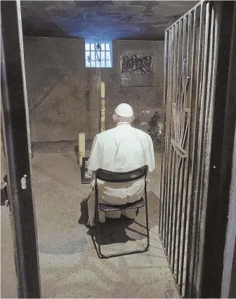  ?? AP PHOTO ?? ‘DON’T NEED WORDS’: Pope Francis prays in the undergroun­d prison cell at the former Nazi German death camp of Auschwitz in Oswiecim, Poland, yesterday.