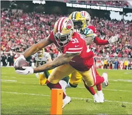  ?? Tony Avelar Associated Press ?? RAHEEM MOSTERT scores one of his four touchdowns on a nine-yard run in the second quarter. He finished with a team-record 220 yards rushing.