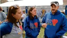  ?? JOHN TLUMACKI/GLOBE STAFF ?? From left: Bonnie Fleischer, Erin Daly, and her husband, Elliott Nerland, raise money in the name of Krystle Campbell.