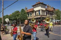  ??  ?? Members of the Normandy High School marching band perform a small parade in the Central West End, a St. Louis neighborho­od on the eastern edge of Forest Park.