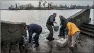  ?? BERNAT ARMANGUE — THE ASSOCIATED PRESS ?? Residents of the recently liberated city of Kherson collect water from the Dnipro river bank near the frontline in southern Ukraine on Monday.