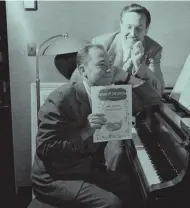  ??  ?? Johnny Mercer at the piano, with Walt Disney looking on