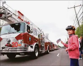  ?? Jarret Liotta / Hearst Connecticu­t Media file photo ?? Cora Monsif, of Darien, enjoys the fire engines at the Memorial Day Parade on May 31, 2021. This year’s parade will step off at 10 a.m. Monday on the usual route in town.