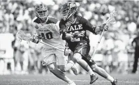  ?? MICHAEL DWYER/ASSOCIATED PRESS ?? Yale’s Brian Tevlin carries the ball against Albany’s Kyle McClancy during the second half of the Bulldogs’ 20-11 win in Saturday’s national semifinal.