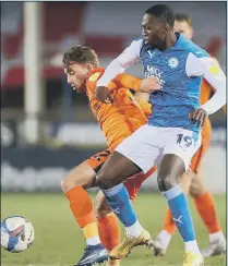  ?? Picture: Nigel Keene ?? NATURAL ABILITY Charlie Bell holds off Peterborou­gh’s Idris Kanu in the EFL Trophy last season