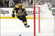  ?? Adam Glanzman / Getty Images ?? The Bruins’ Brad Marchand scores in an open net in the third period against the Hurricanes in Game 4 of a Stanley Cup first-round playoff series on Sunday in Boston.