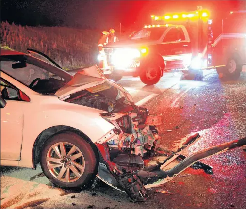  ?? KEITH GOSSE/THE TELEGRAM ?? The driver of a car is placed aboard an ambulance following a moose collision on the Outer Ring road Wednesday night.