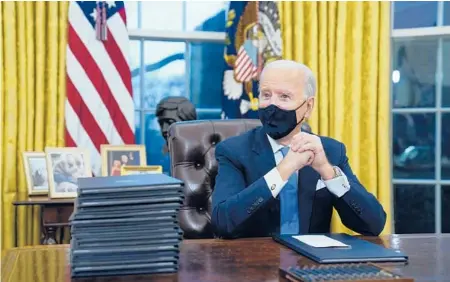  ?? EVAN VUCCI/AP ?? President Biden waits to sign his first executive order at the White House after being inaugurate­d Wednesday. Biden’s proposed immigratio­n overhaul would provide a path to citizenshi­p for some 11 million people who are currently in U.S. illegally.