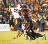  ?? Don Boomer / Associated Press ?? Cal’s Evan Rambo makes an intercepti­on in front of San Diego State’s Mikah Holder in a Sept. 10 loss. A knee injury will keep Rambo from playing against Utah on Saturday.