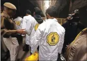  ?? PIC/NAVEEN SHARMA ?? Team of Forensic Science Laboratory Delhi coming out from the factory where 43 workers died, in New Delhi on Monday