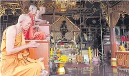  ??  ?? RIGHT Statues of King Taksin and revered monks erected in the King Taksin Shrine for visitors to pay respect to.