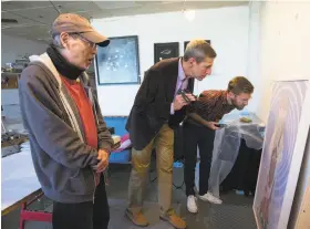  ?? Ruth Fremson / New York Times 2014 ?? Artist Patrick Nagatani (left) speaks with the museum curators Don Bacigalupi (center) and Chad Alligood at his studio in Albuquerqu­e in 2014.