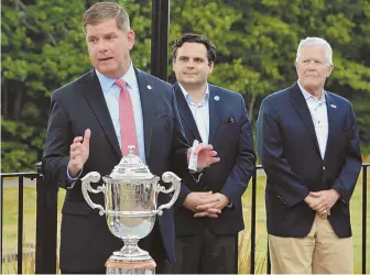  ?? STAFF PHOTO BY CHRIS CHRISTO ?? YOUR HONOR, YOUR HONOR: Boston Mayor Martin J. Walsh (left) speaks at the trophy ceremony for the 110th Massachuse­tts Amateur yesterday in Hyde Park.