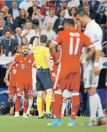 ?? FOTO: REUTERS ?? ►► Kassai expulsa a Vidal, mientras Cristiano le comenta algo a Douglas Costa.