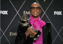  ?? ASHLEY LANDIS/ASSOCIATED PRESS ?? Host RuPaul holds the trophy after “RuPaul’s Drag Race” won the Emmy for outstandin­g reality TV competitio­n during the Emmy Awards on Jan. 15 at Los Angeles.