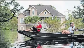  ?? SEAN RAYFORD GETTY IMAGES ?? People navigate flood waters caused by Hurricane Florence near the Waccamaw River on Sunday in Conway, S.C. Flood waters are continuing to rise in the area.