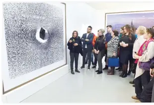  ??  ?? Russian visitors admire an exhibit at the Saudi cultural exhibition in Moscow. (SPA)