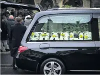  ??  ?? Hearse with floral tributes to Charlie