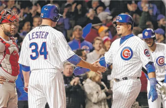  ?? | CHARLES REX ARBOGAST/ AP ?? Kyle Schwarber ( right) is greeted at the plate by pitcher Jon Lester, who scored in front of him on his three- run home run in the fourth inning Tuesday.