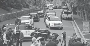  ?? DAVID SWANSON/AFP VIA GETTY IMAGES ?? Police and members of the media gather outside Sean “Diddy” Combs’ home in Los Angeles on March 25.