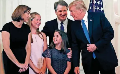  ?? [AP PHOTOS] ?? President Donald Trump talks with Judge Brett Kavanaugh and his family after announcing his nomination to the Supreme Court in the East Room of the White House on Monday.