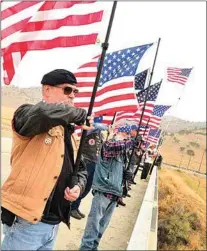  ?? NICK SMIRNOFF / FOR TEHACHAPI NEWS ?? Standing tall, participan­ts remind passing motorists of the significan­ce of Sept. 11. “9/11 we must never forget,” many chanted.