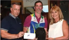  ??  ?? Drogheda Wheelers chairperso­n Andrew Watters and Rosemary Mullen, wife of the late Mark, present Niall Craven with the overall trophy for the Drogheda Wheelers Mark Mullen Memorial League.