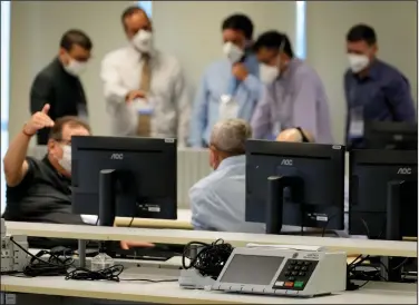  ?? (AP/Eraldo Peres) ?? Analysts test the electronic voting system at the headquarte­rs of the Supreme Electoral Court Friday in Brasilia, Brazil.