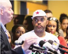  ?? | ASHLEE REZIN/ SUN- TIMES ?? Kofi Ademola ( right) of Black Lives Matter- Chicago, listens as Craig Futterman, founder of the Civil Rights and Police Accountabi­lity Project, discusses a lawsuit seeking federal court oversight of the Chicago Police Department filed Wednesday.