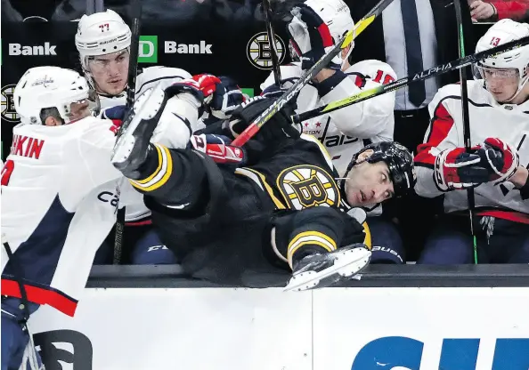  ?? ELISE AMENDOLA / THE ASSOCIATED PRESS ?? Bruins defenceman Zdeno Chara tumbles into the Capitals bench courtesy of an Alex Ovechkin check during action in Boston on Thursday. Chara might not be as physical as he once was, but at age 41 he remains one of the league’s best on the blue-line.