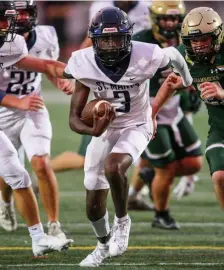  ?? STEw miLNE pHOTOs / bOsTON HEraLd ?? ‘A REALLY BIG WIN FOR US’: St. Mary’s Ali Barry runs the ball during the first half against Bishop Feehan on Friday night in Attleboro. At left, St. Mary’s Tommy Falasca (55) and Christophe­r Sazo (56) celebrate a tackle during the first half.