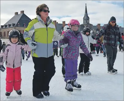  ?? DAVID JALA/CAPE BRETON POST ?? Glace Bay’s Terese MacMullin holds onto nine-year-old granddaugh­ter Victoria MacMullin, right, and neighbour Lilly Moussa, 6, during the Fortress of Louisbourg’s skating party on Sunday that was held to commemorat­e the centennial of the establishm­ent...