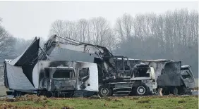  ?? THE ASSOCIATED PRESS ?? Burned-out vans stand near a motorway in central France Wednesday. Police say 15 armed
assailants attacked two vans, snatching millions of euros in jewels.